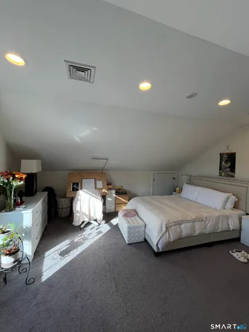 a bedroom with bed and a couch