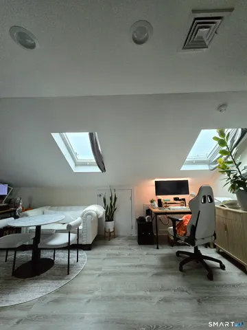 a view of a workspace with furniture and a workspace