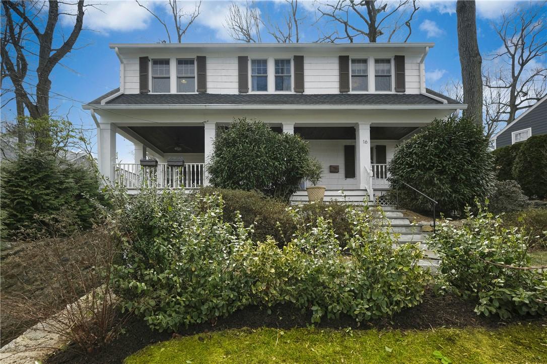 a house with lots of trees in front of it