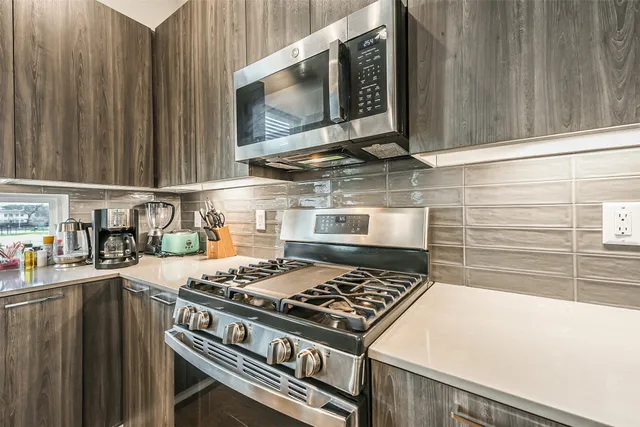 a kitchen with kitchen sink a counter top space and a window