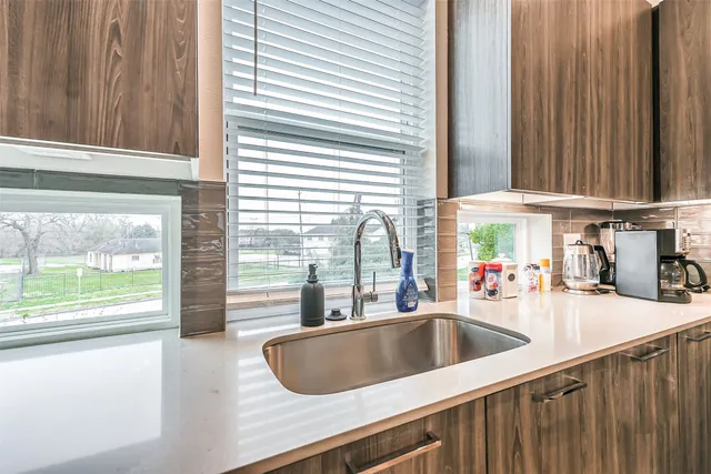 a kitchen with kitchen island granite countertop stainless steel appliances and a refrigerator