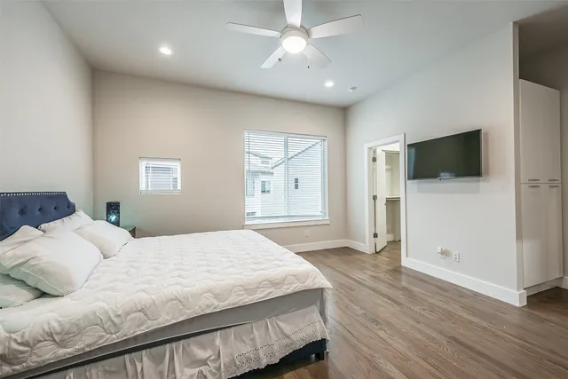 a large bathroom with a granite countertop tub a sink and a large mirror