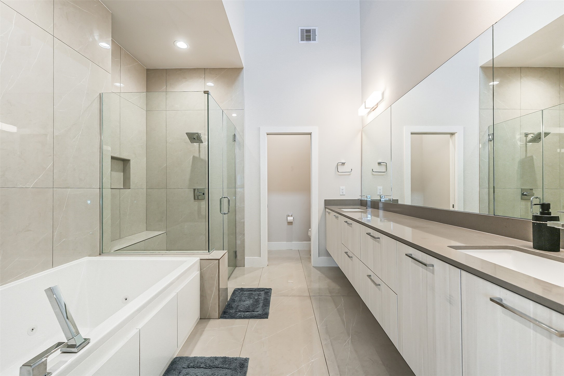 2136 Dennis Street Houston, TX 77004 - Photo 26 of 49 a large bathroom with a granite countertop tub a sink and a large mirror