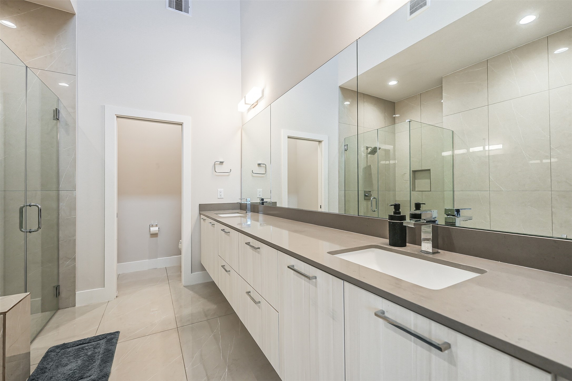 2136 Dennis Street Houston, TX 77004 - Photo 27 of 49 a bathroom with a sink double vanity granite tub shower and a mirror