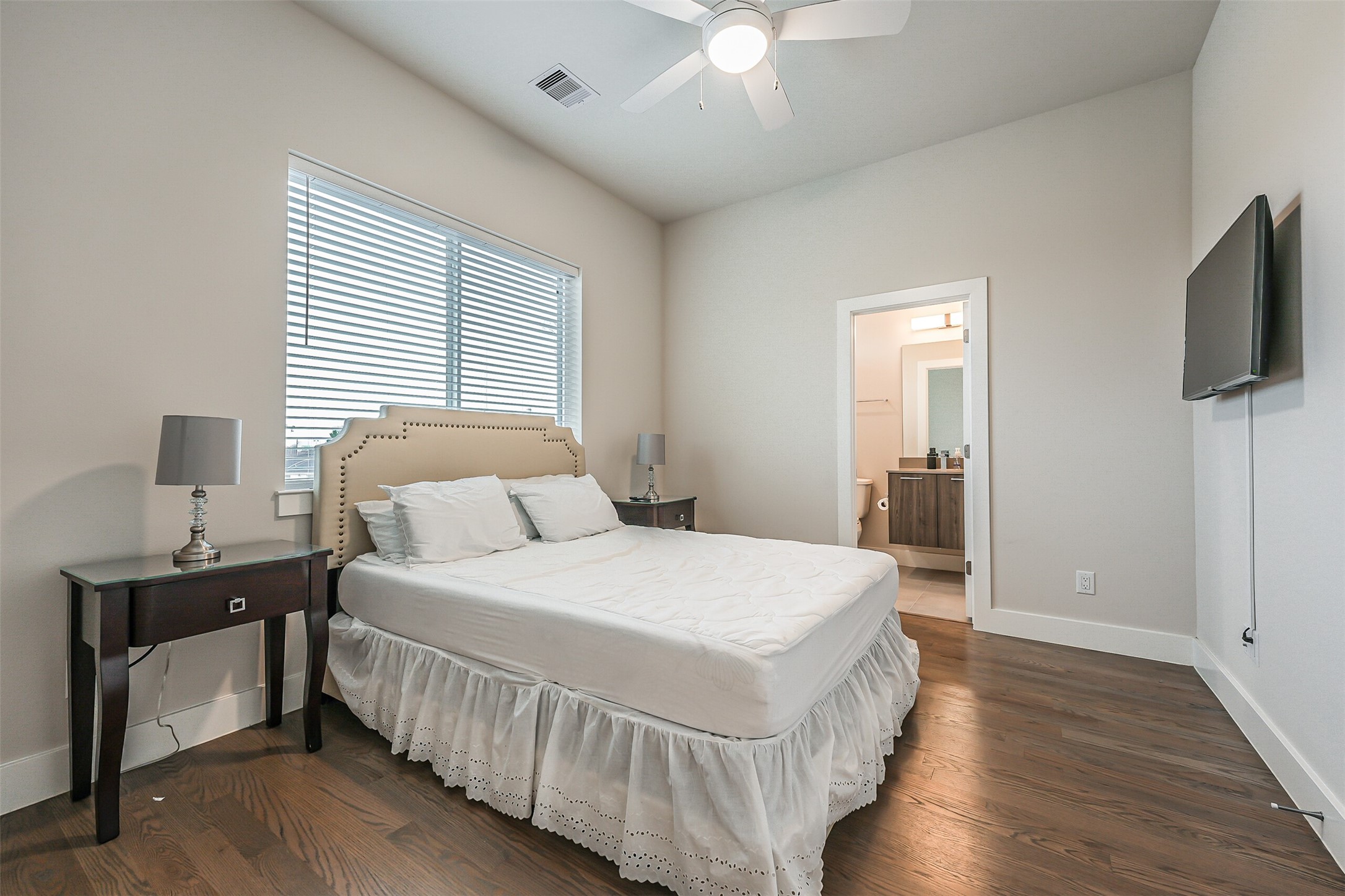 2136 Dennis Street Houston, TX 77004 - Photo 32 of 49 a bedroom with a bed and a flat screen tv