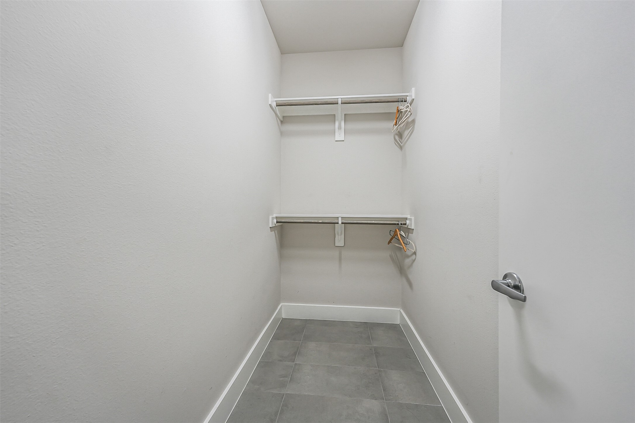 2136 Dennis Street Houston, TX 77004 - Photo 37 of 49 a view of walk in closet with empty racks