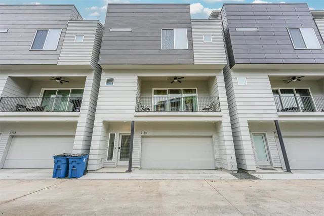 an aerial view of multiple houses with a street
