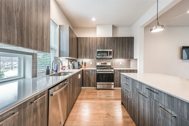 a kitchen with a stove a sink and a microwave