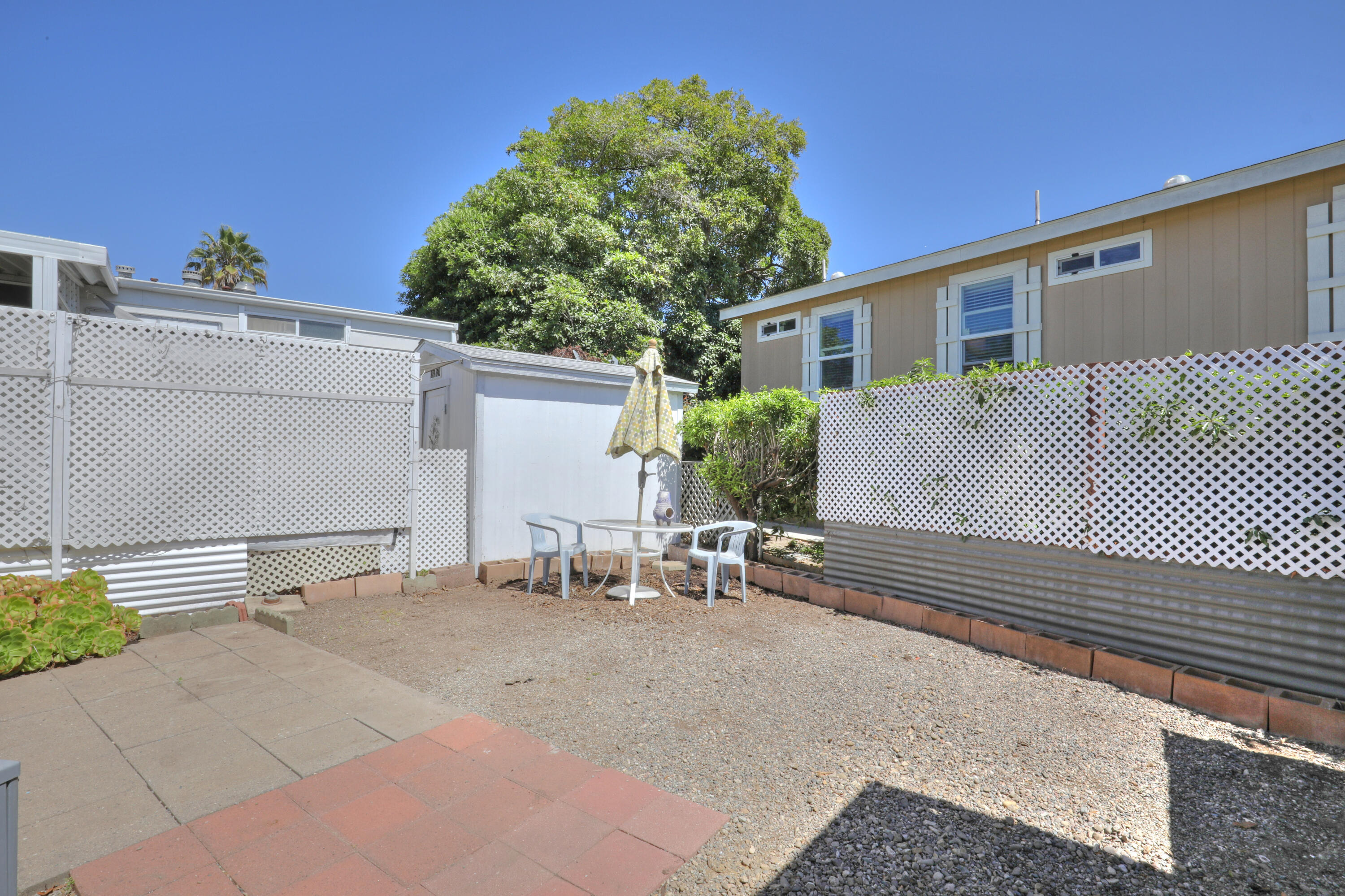 333 Old Mill Road, Unit 102 Santa Barbara, CA 93110 - Photo 14 of 16 a backyard of a house with table and chairs