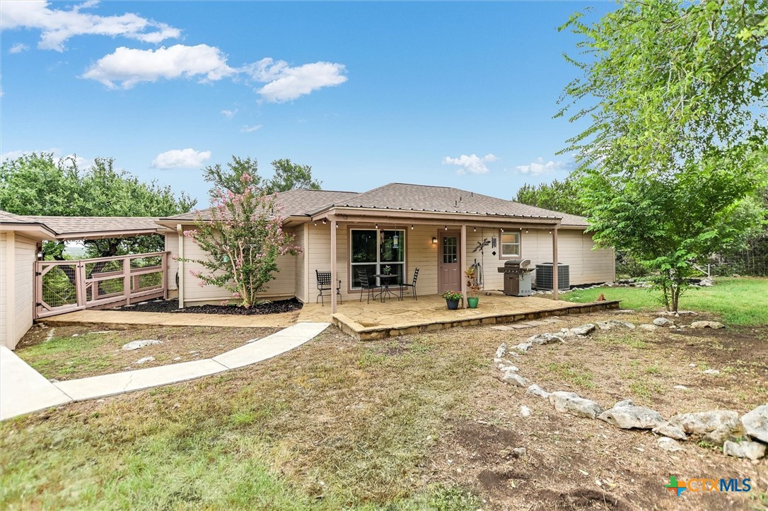 60 Crazy Cross Road Wimberley, TX 78676 - Photo 15 of 20 Flagstone walkway from the back patio to the breeze way. Ideal entertaining area.
