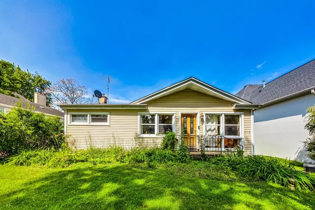 a view of a house with a yard balcony and sitting area