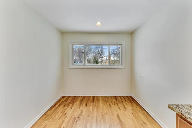 a view of a room with wooden floor and window