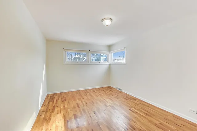 a view of a room with wooden floor