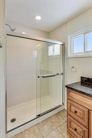 a bathroom with a shower and a sink