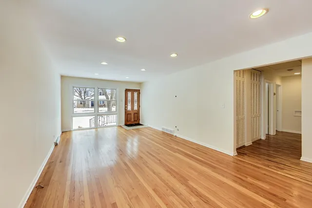 a view of a room with wooden floor