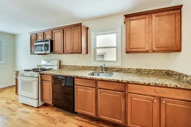 a bathroom with a granite countertop sink and a stove