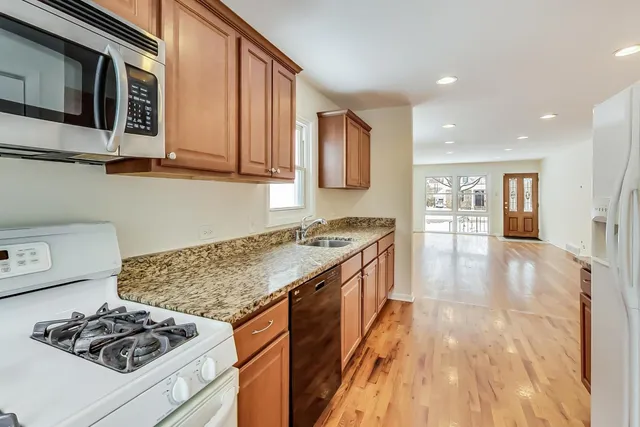 a kitchen with stainless steel appliances granite countertop a stove and a sink