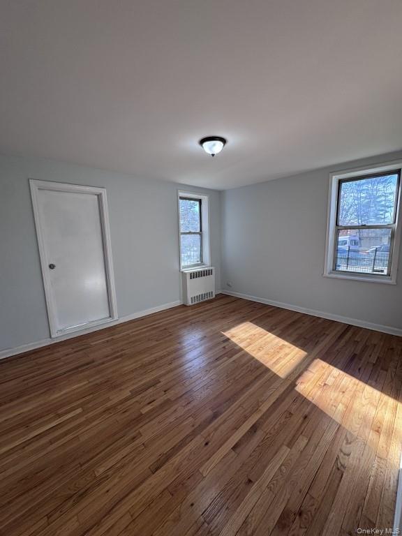 5639 Netherland Avenue, Unit 1B Bronx, NY 10471 - Photo 6 of 8 Spare room featuring wood-type flooring and radiator