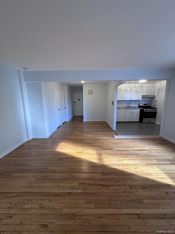 5639 Netherland Avenue, Unit 1B Bronx, NY 10471 - Photo 7 of 8 Unfurnished living room with baseboards and dark wood-type flooring
