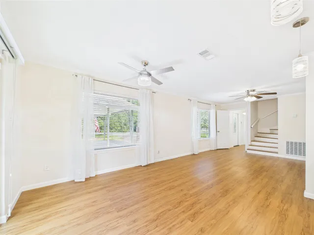 a view of empty room with wooden floor