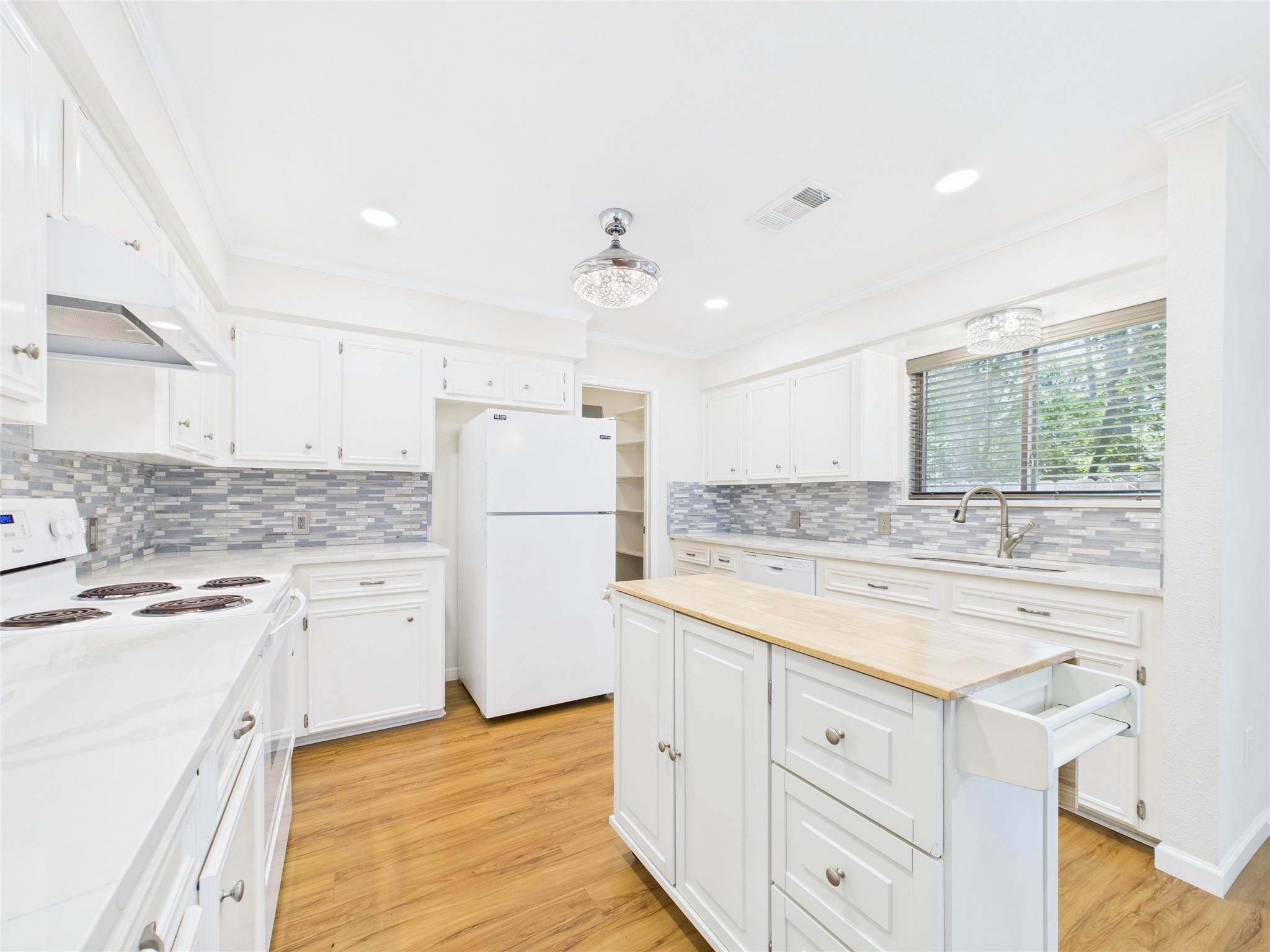 36 Corkwood Trinity, TX 75862 - Photo 17 of 49 a kitchen with white cabinets and white appliances