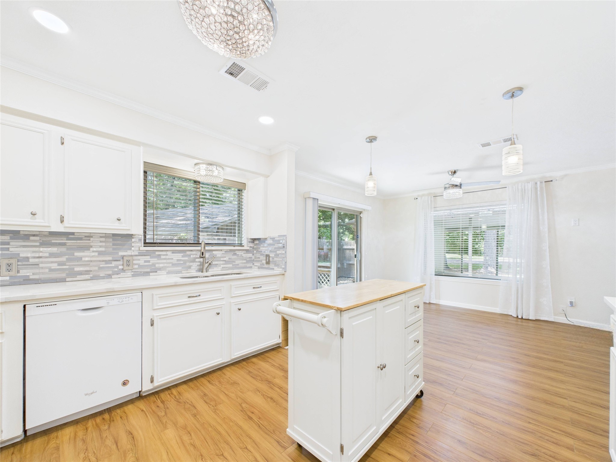 36 Corkwood Trinity, TX 75862 - Photo 18 of 49 a large white kitchen with a large window a sink and cabinets