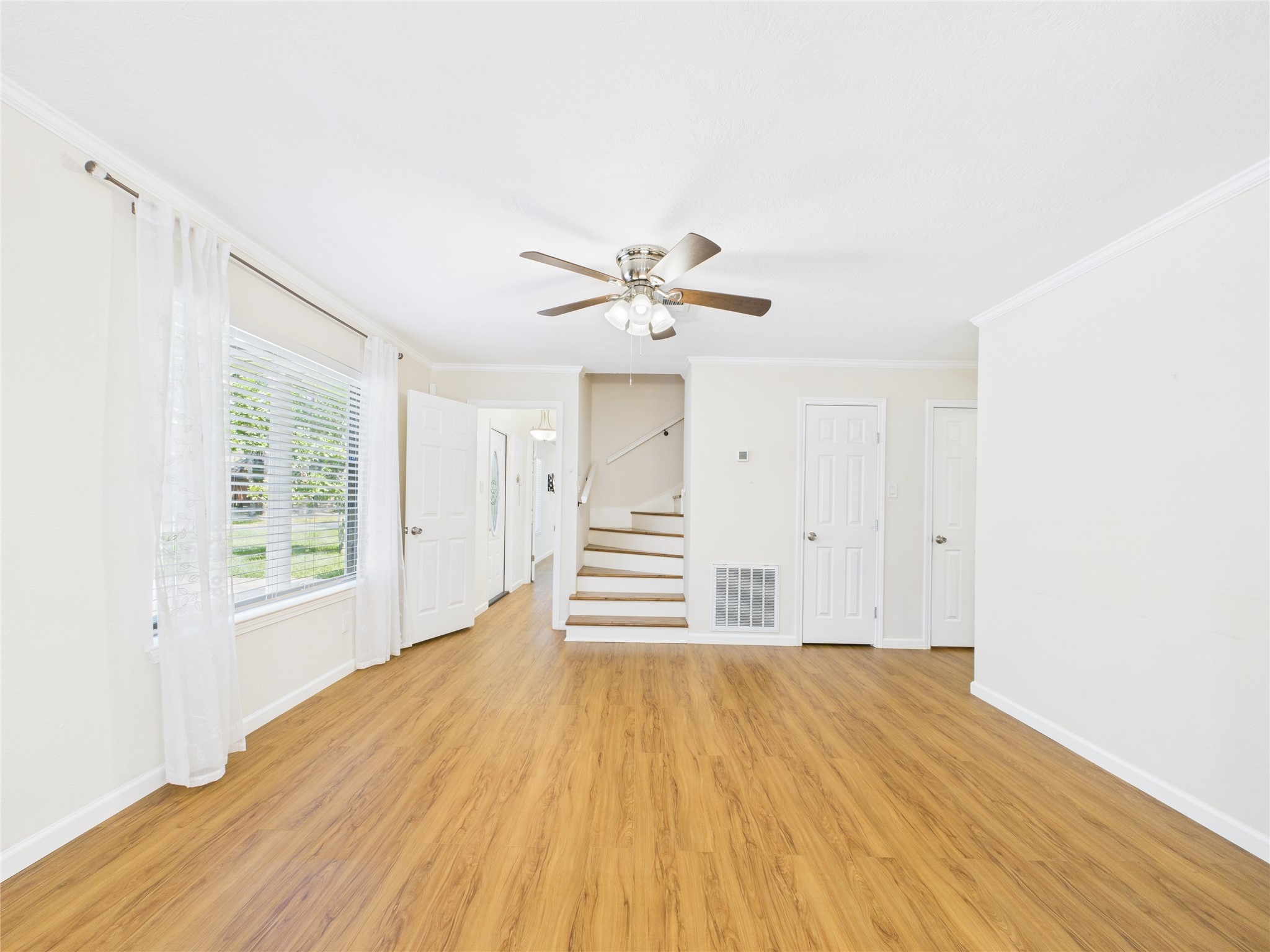 36 Corkwood Trinity, TX 75862 - Photo 21 of 49 a view of a room with wooden floors and ceiling fan