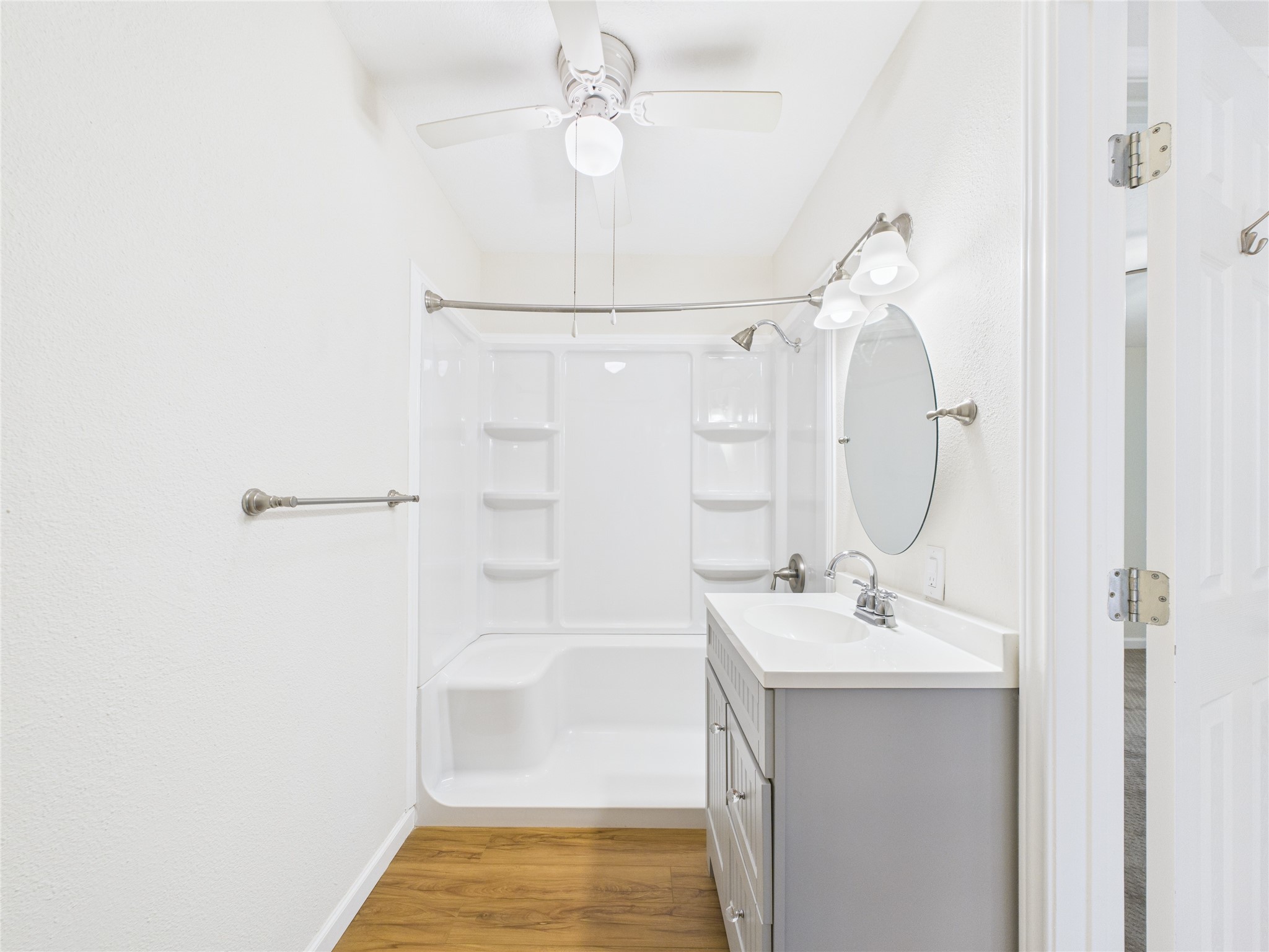 36 Corkwood Trinity, TX 75862 - Photo 25 of 49 a bathroom with a sink a mirror and a shower