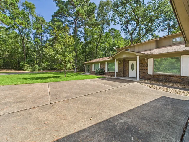 a front view of a house with a garden and yard