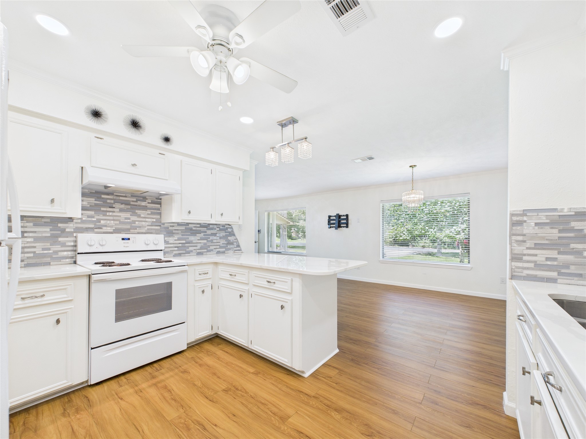 36 Corkwood Trinity, TX 75862 - Photo 37 of 49 a kitchen with granite countertop white cabinets and white appliances