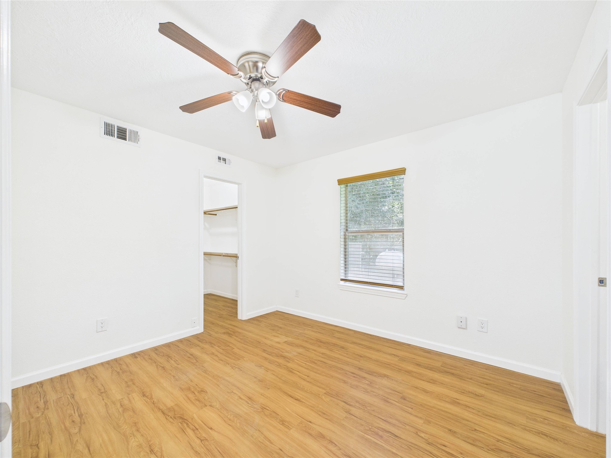 36 Corkwood Trinity, TX 75862 - Photo 41 of 49 a view of a big room with wooden floor and a ceiling fan