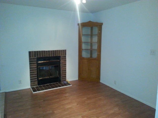 932 North 15th Street Rochelle, IL 61068 - Photo 5 of 15 a view of an empty room with wooden floor fireplace and a window