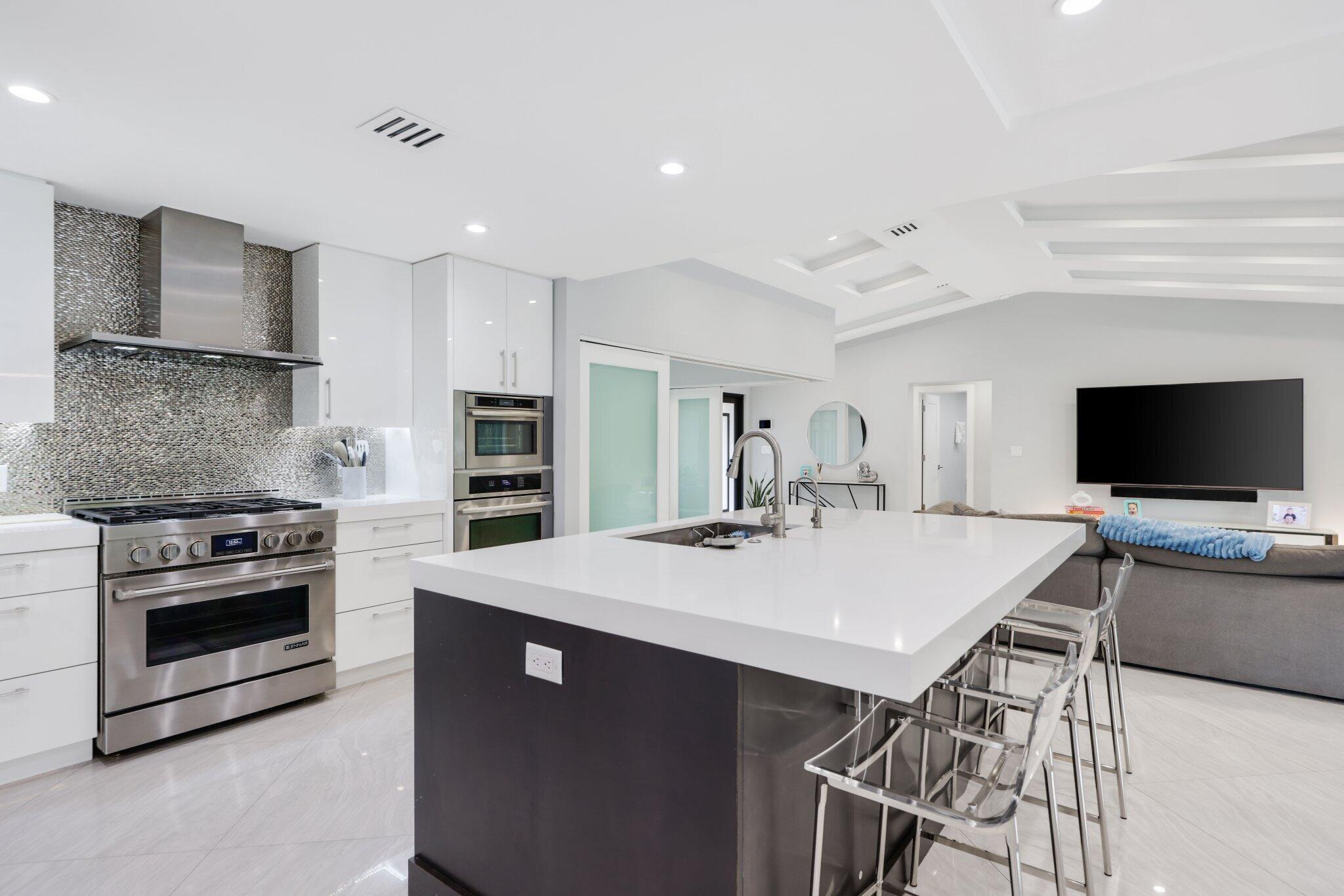 20984 Shady Vista Lane Boca Raton, FL 33428 - Photo 16 of 54 a large kitchen with a stove a table and chairs