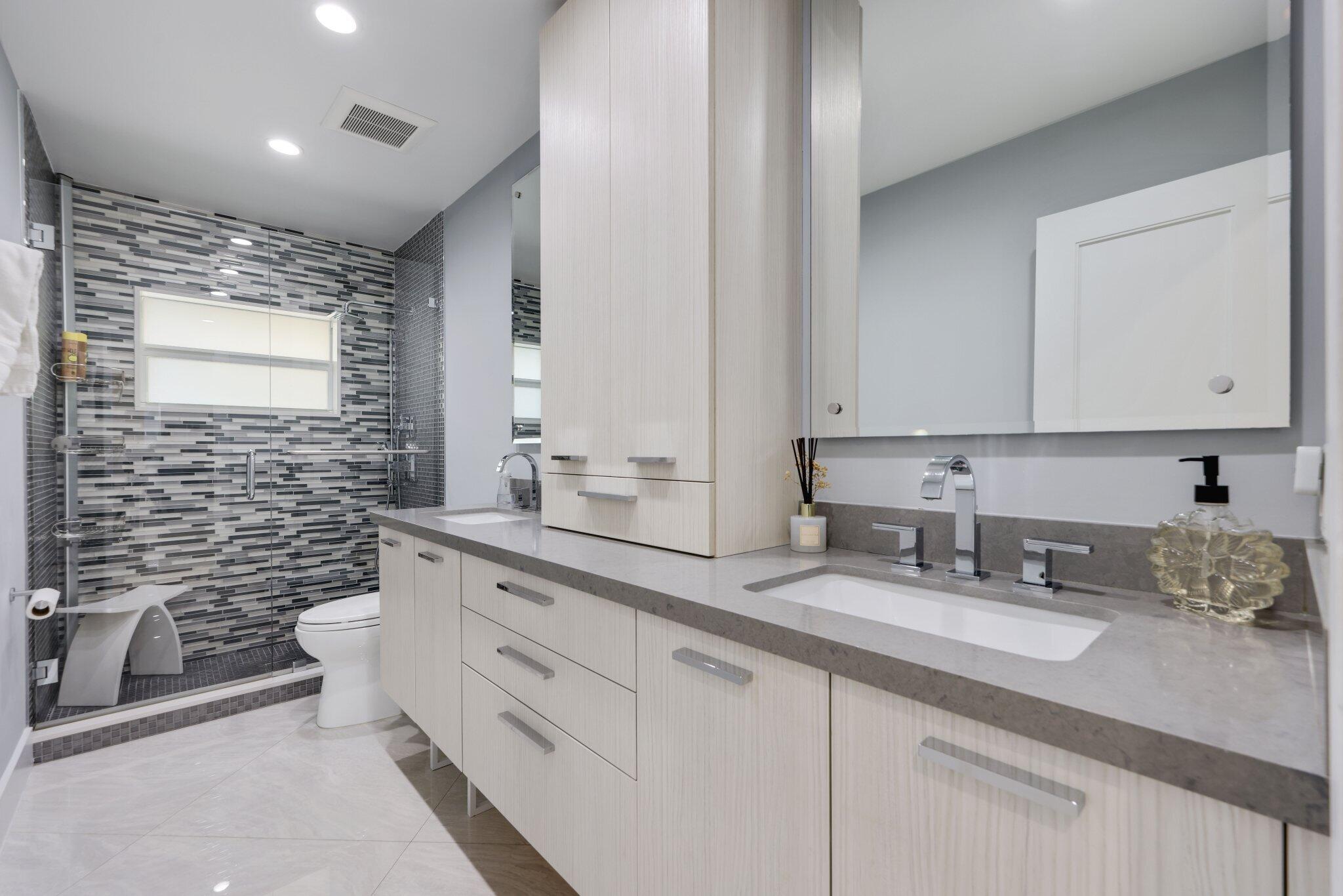 20984 Shady Vista Lane Boca Raton, FL 33428 - Photo 24 of 54 a bathroom with a double vanity sink a toilet and a mirror