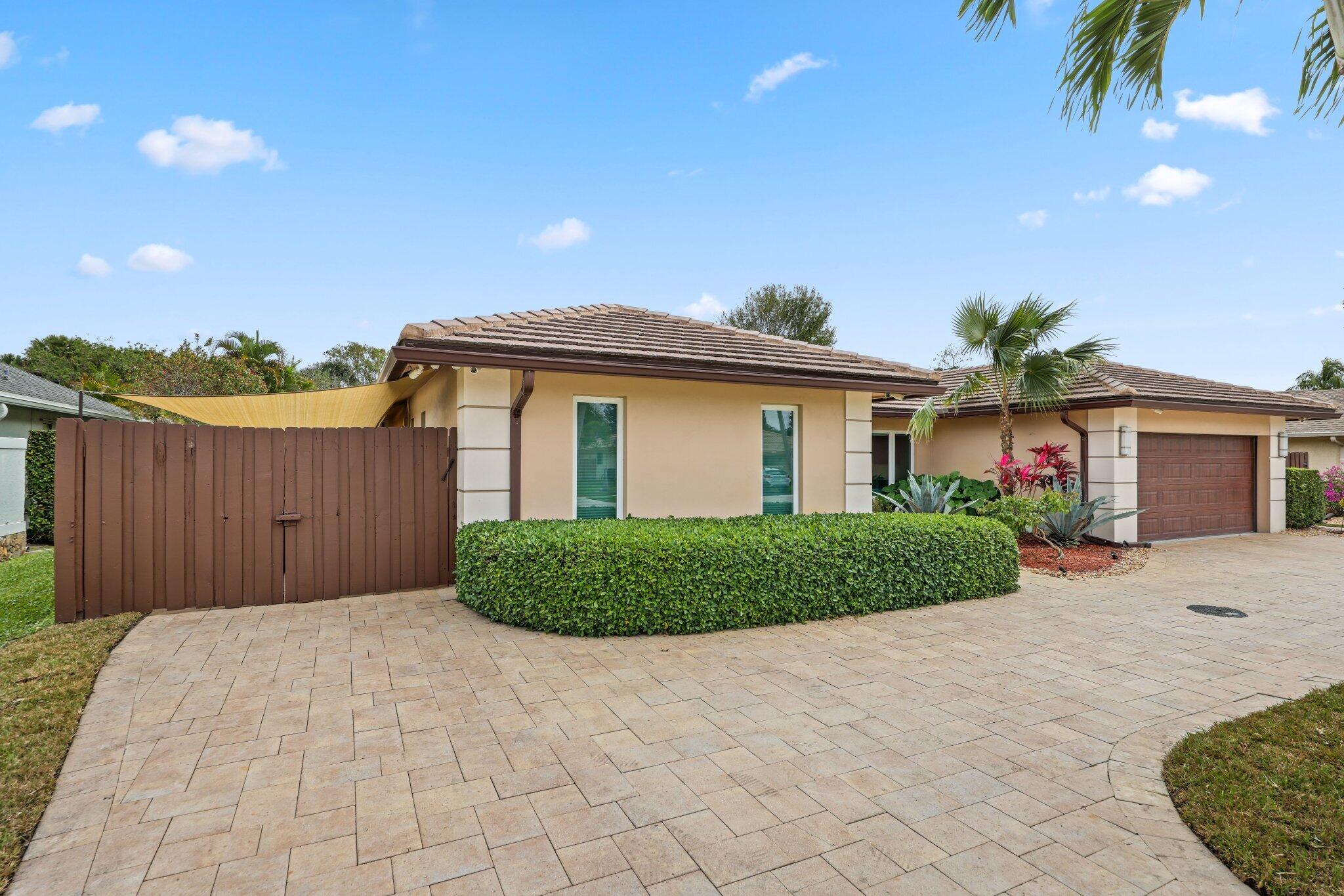 20984 Shady Vista Lane Boca Raton, FL 33428 - Photo 35 of 54 a front view of a house with a yard and garage