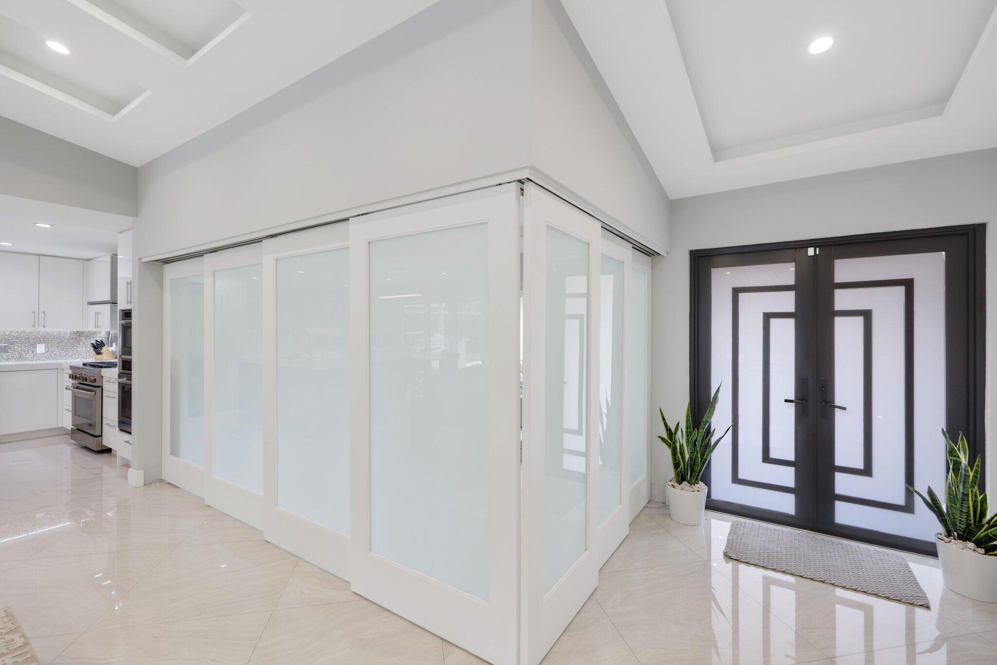 20984 Shady Vista Lane Boca Raton, FL 33428 - Photo 9 of 54 a view of a hallway with dining area and chandelier