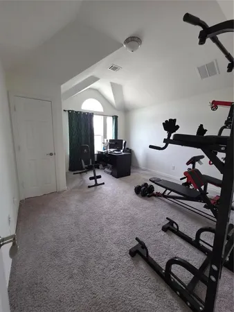 a room with gym equipment and a window