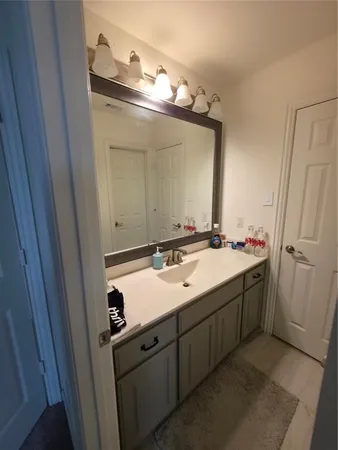 a bathroom with a double vanity sink and mirror