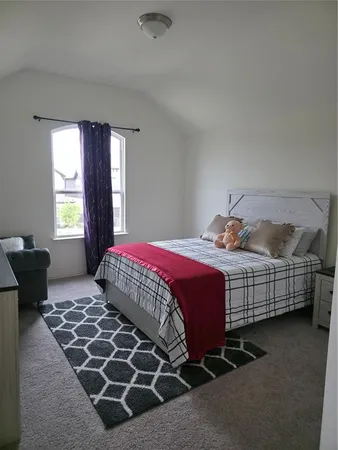 a bedroom with a bed and window