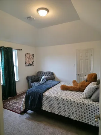 a bedroom with bed and a window