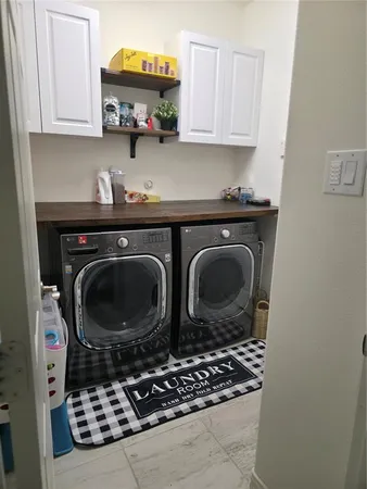 a kitchen with stove top oven and cabinets