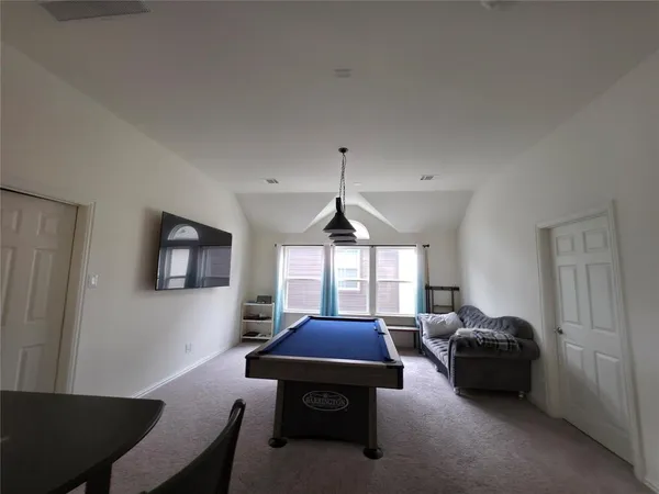 a living room with furniture a window and a flat screen tv