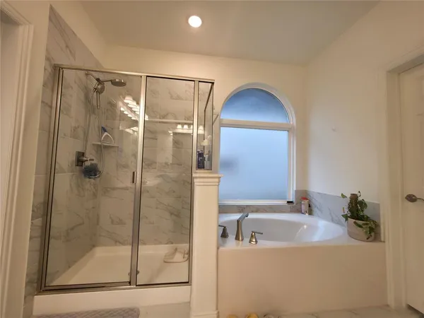 a bathroom with a bathtub and a shower