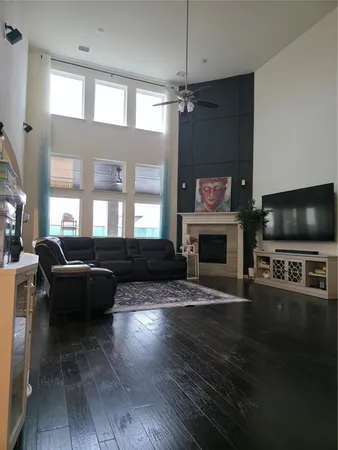 a living room with furniture a flat screen tv and a fireplace