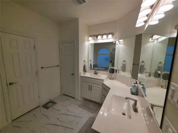 a bathroom with a sink tub and mirror