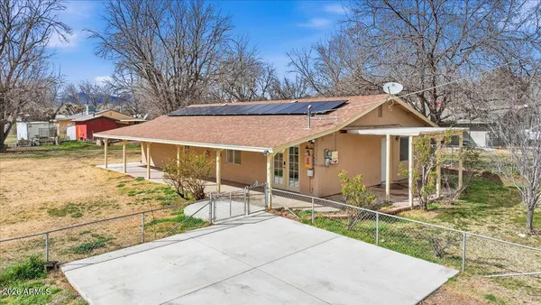 a view of a house with backyard porch and sitting area