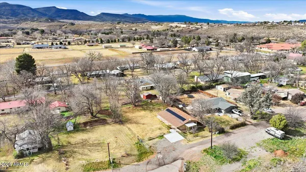 an aerial view of residential houses with outdoor space and lake view