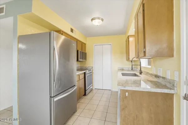 a kitchen with a sink a counter top space and cabinets