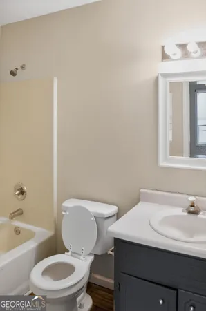 a white toilet sitting next to a bathroom sink