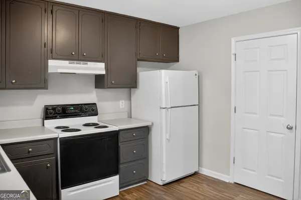 a kitchen with a stove and a refrigerator